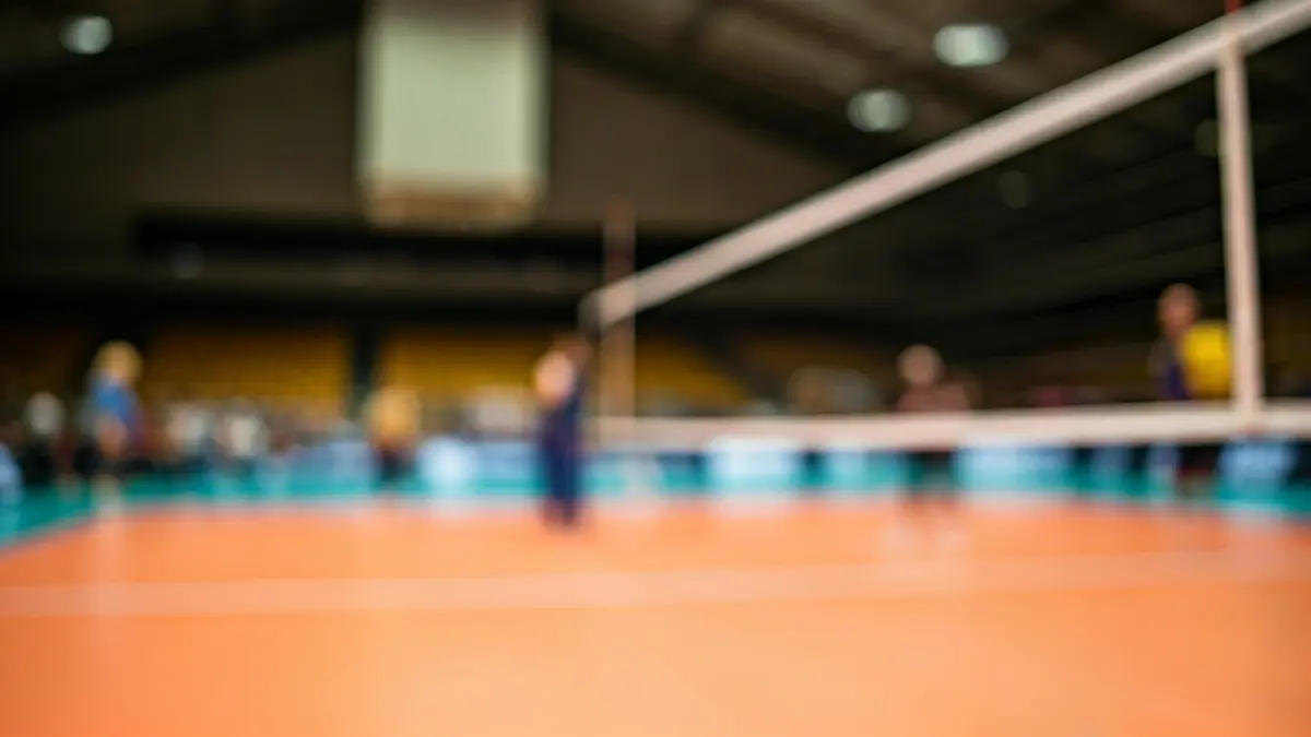 Imaxe xenérica dunha rede de voleibol nun pavillón deportivo.