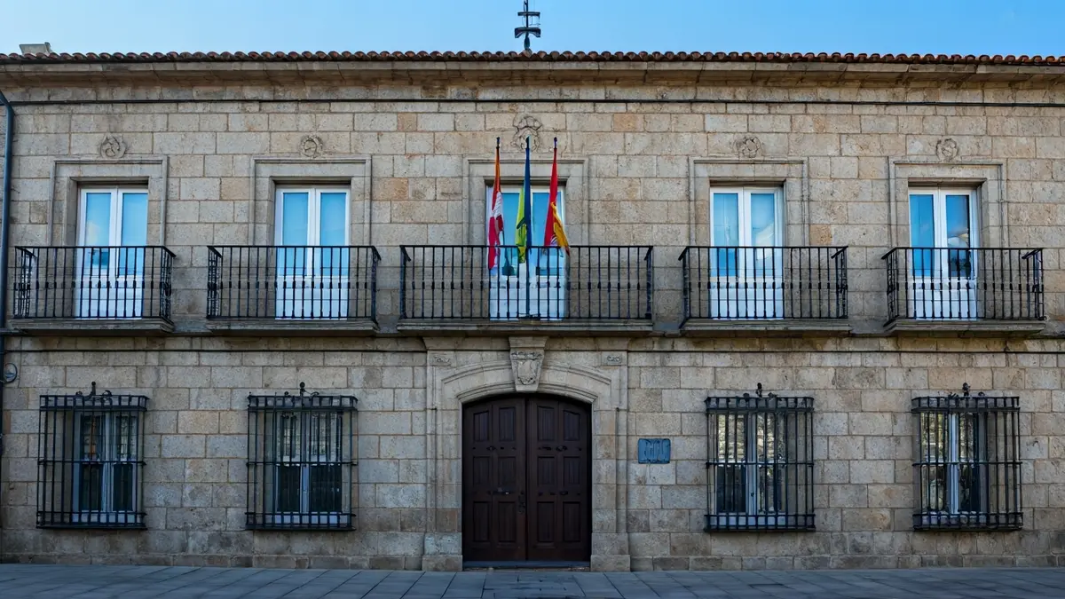 Imagen de la fachada de un ayuntamiento gallego con balcón de hierro forjado.